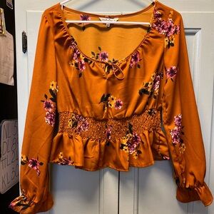 Indulge floral brown peplum top. Size Medium long sleeves.